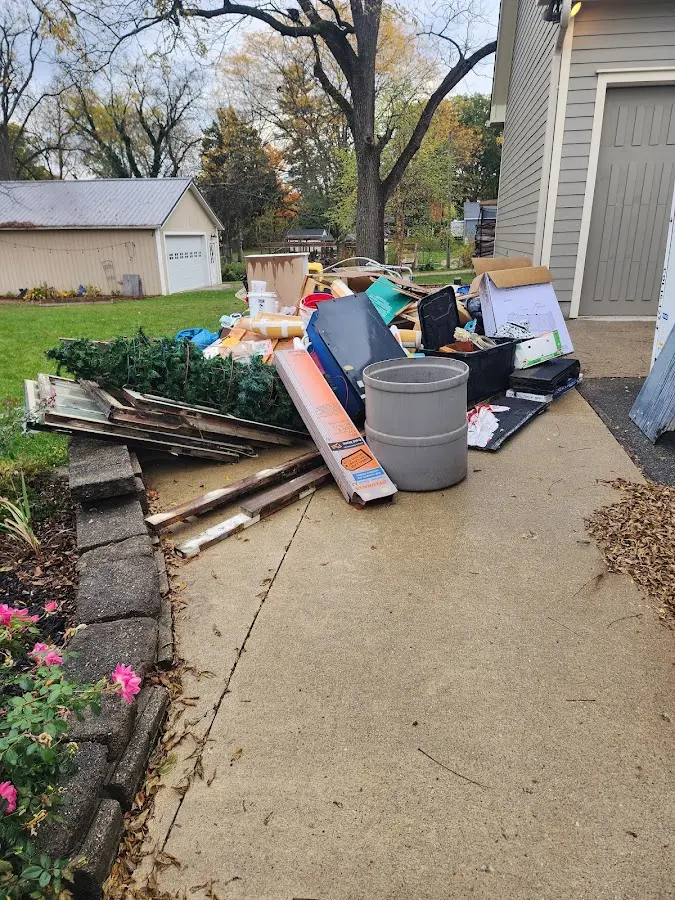 Dumpster being loaded with debris for Roofing Dumpster Rental in Gloversville